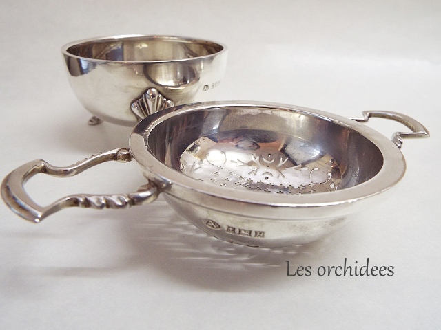 silver tea strainer with saucer